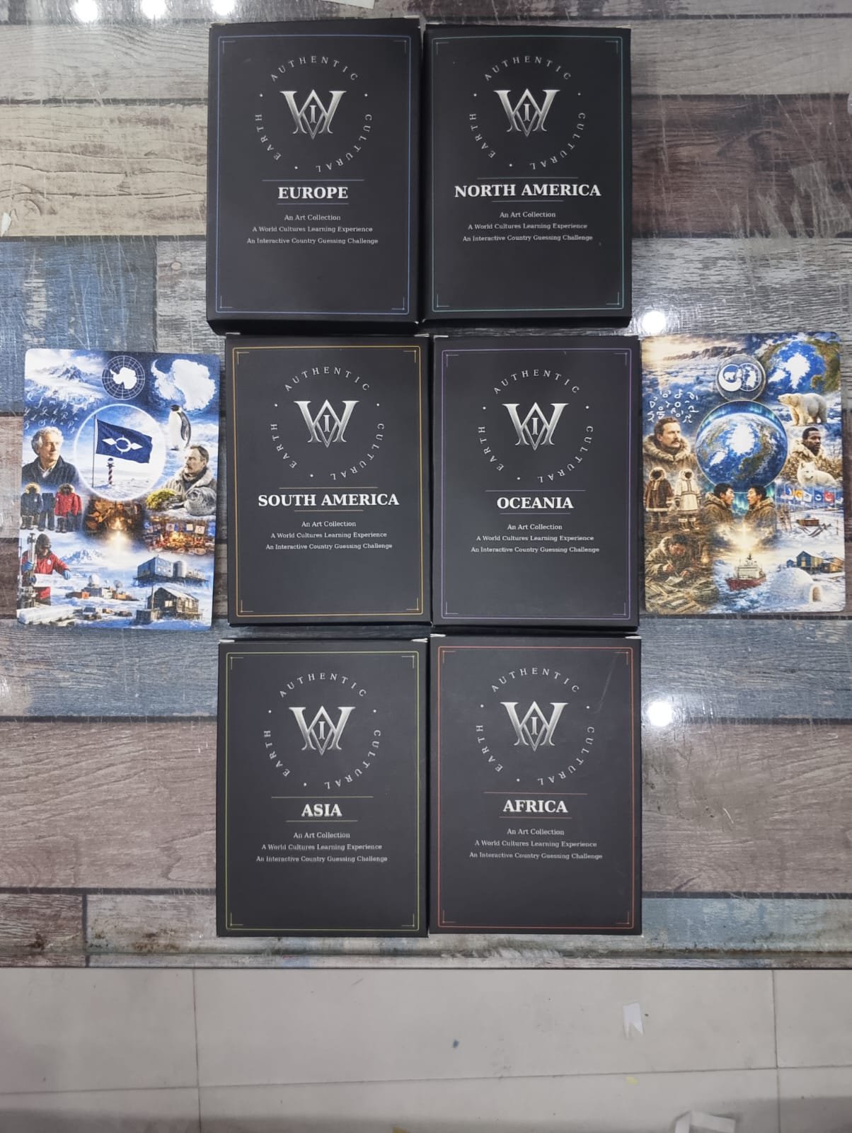 Six continental packs displayed with Arctic and Antarctica cultural cards